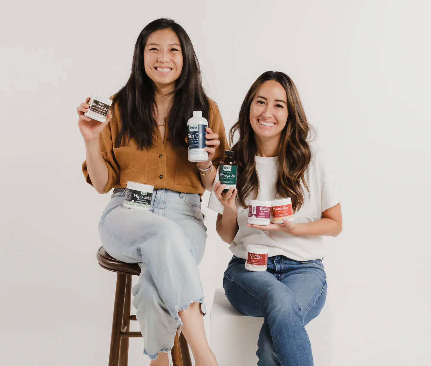 Dr. Michelle Dulake and Emily Hsu holding some Fera Pets products